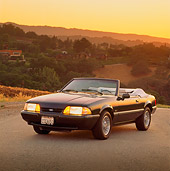 MST 01 RK0049 01
1989 Ford Mustang Convertible Green 3/4 Front View On Pavement Trees Background