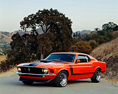 MST 01 RK0076 01
1970 Ford Mustang Boss 302 Orange And Black 3/4 Front View On Pavement By Trees And Hills