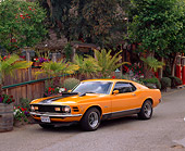 MST 01 RK0182 04
1970 Ford Mustang Mach 1 Grabber Orange 3/4 Front View On Pavement By Plants And Trees