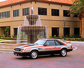 MST 01 RK0203 01
1979 Ford Mustang Pace Car Front 3/4 View By Fountain And Building