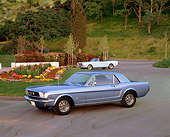 MST 01 RK0349 01
1966 Ford Mustang Metallic Blue 3/4 Side View On Pavement By Flowers And Trees