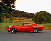 MST 01 RK0366 02
1970 Ford Mustang Boss 429 Orange Profile On Pavement By Grass And Trees