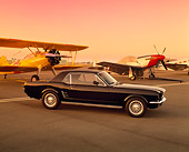 MST 01 RK0372 05
1966 Ford Mustang Coupe Black 3/4 Front View On Pavement By Airplanes