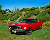 MST 01 RK0540 04
1969 Mustang Fastback With Mach 1 Modifications Red 3/4 Front View On Grass By Plants