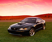 MST 01 RK0547 03
2001 Ford Mustang Bullet Green 3/4 Front View On Grass Hills Red Sky