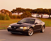 MST 01 RK0549 03
2001 Ford Mustang Bullitt Green 3/4 Front View On Road By Grass And Trees