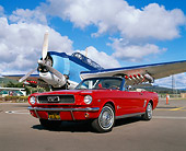 MST 01 RK0562 03
1966 Ford Mustang Convertible Red Low 3/4 Front View On Pavement By Airplane Cloudy Sky