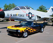 MST 01 RK0582 01
1966 Ford Mustang Black With Flames Convertible 3/4 Front View On Pavement By Military Plane
