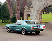 MST 01 RK0674 01
1965 Ford Mustang Green Black Stripes 3/4 Rear View On Pavement By Arch