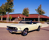 MST 01 RK0719 01
1969 Ford Mustang Convertible Yellow 3/4 Front View On Pavement By Building And Trees