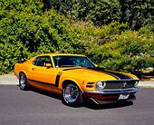 MST 01 RK0722 02
1970 Ford Mustang Boss 302 Orange Black Stripes 3/4 Front View On Pavement By Shrubs
