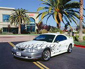 MST 01 RK0769 01
1997 Ford Mustang GT White Silver Flames 3/4 Front View On Pavement By Building And Trees