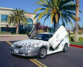 MST 01 RK0771 03
1997 Ford Mustang GT White Silver Flames 3/4 Front View Doors Open By Building And Trees