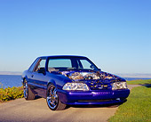 MST 01 RK0777 06
1987 Ford Mustang Blue Purple 3/4 Front View On Pavement By Water