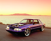 MST 01 RK0779 03
1987 Ford Mustang Blue Purple 3/4 Front View On Pavement By Water