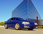 MST 01 RK0788 01
1988 Ford Mustang GT Blue Low 3/4 Front View On Pavement By Building