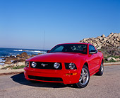 MST 01 RK0797 02
2005 Ford Mustang GT Coupe Red Low 3/4 Front View On Pavement By Rocks And Ocean