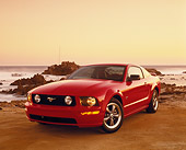 MST 01 RK0812 01
2005 Ford Mustang GT Coupe Red 3/4 Front View On Sand By Rocks And Ocean Filtered