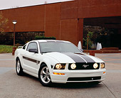 MST 01 RK0861 04
2005 Ford Mustang GT White Black Stripes 3/4 Front View On Pavement By Building