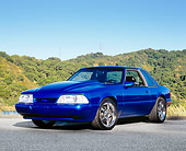MST 01 RK0899 03
1990 Ford Mustang Blue 3/4 Front View On Pavement By Hills