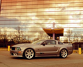 MST 02 RK0073 05
2005 Ford Saleen Mustang Supercharged Silver 3/4 Side View On Pavement By Glass Building Filtered