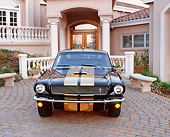 MST 03 RK0075 01
1966 Shelby Hertz Mustang Black And Gold Head On Shot In Front Of House Parking Lights On