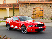 MST 03 RK0908 01
2011 Shelby Ford Mustang GT500 SVT Red With White Stripes 3/4 Front View On Pavement By Stone Building