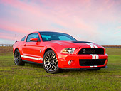 MST 03 RK0913 01
2011 Shelby Ford Mustang GT500 SVT Red With White Stripes 3/4 Front View On Grass At Dusk