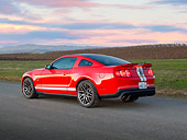 MST 03 RK0914 01
2011 Shelby Ford Mustang GT500 SVT Red With White Stripes 3/4 Rear View On Pavement At Dusk