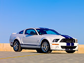 MST 03 RK0165 01
2007 Ford Shelby GT500 White Blue Stripe Low 3/4 Side On Pavement