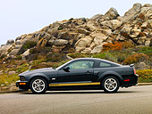 MST 03 RK0172 01
2006 Ford Shelby GT-H Black And Gold Profile View On Pavement By Rocks