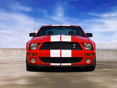 MST 03 RK0174 01
2007 Ford Shelby GT500 Red And White Low Head On View On Pavement Blue Sky