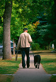 PEO 02 DB0005 01
Elderly Man Walking With Black Labrador Retriever On Sidewalk