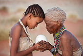 PEO 08 MH0016 01
Elderly San Woman Offering Ostrich Egg As Gift To Young Girl For Making Jewelry