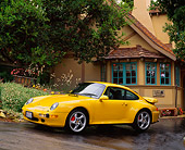 POR 01 RK0010 01
1996 Porsche Twin Turbo Yellow 3/4 Side View On Pavement By House