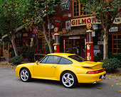 POR 01 RK0012 06
1996 Porsche Twin Turbo Yellow 3/4 Rear View By Gas Station