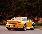 POR 01 RK0016 02
1996 Porsche Twin Turbo Yellow 3/4 Rear View On Pavement Trees Background