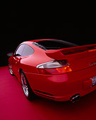 POR 03 RK0132 10
2003 Porsche Turbo X50 Red Close Up Wide Angle 3/4 Rear View Shot On Red Floor Studio