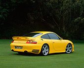 POR 03 RK0130 07
2001 Porsche R Turbo Yellow Rear 3/4 View On Grass Trees Background
