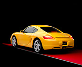 POR 04 RK0649 01
2006 Porsche Cayman S Yellow 3/4 Rear View On Red Floor Studio