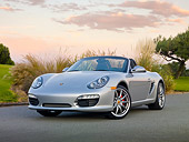 POR 04 RK0848 01
2010 Porsche Boxster S Convertible Silver 3/4 Front View On Pavement By Shrubs