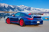 POR 04 RK0920 01
2011 Porsche GT3 RS Blue And Red 3/4 Rear View On Pavement By Water And Snowy Mountains