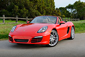 POR 04 RK0957 01
2013 Porsche Boxster Red 3/4 Front View On Pavement By Fence And Trees