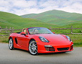 POR 04 RK0958 01
2013 Porsche Boxster Red 3/4 Front View On Pavement By Fence And Grassy Hills