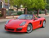 POR 04 RK0959 01
2013 Porsche Boxster Red 3/4 Front View On Pavement By Gated House