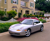 POR 04 RK0372 15
1999 Porsche 911 Carrera Coupe Silver 3/4 Front View On Pavement By House