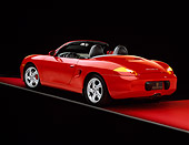 POR 04 RK0427 02
2000 Porsche Boxster S Convertible Red 3/4 Rear View On Red Floor Studio
