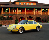 POR 04 RK0428 01
1972 Porsche 911 T Yellow Side 3/4 View On Pavement By Building At Dusk