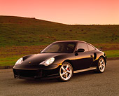 POR 04 RK0459 01
2001 Porsche 911 Twin Turbo Black 3/4 Front View On Pavement By Grass Hills Red Sky
