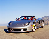 POR 04 RK0575 03
2005 Porsche Carrera GT Convertible Silver 3/4 Front View On Pavement Hill